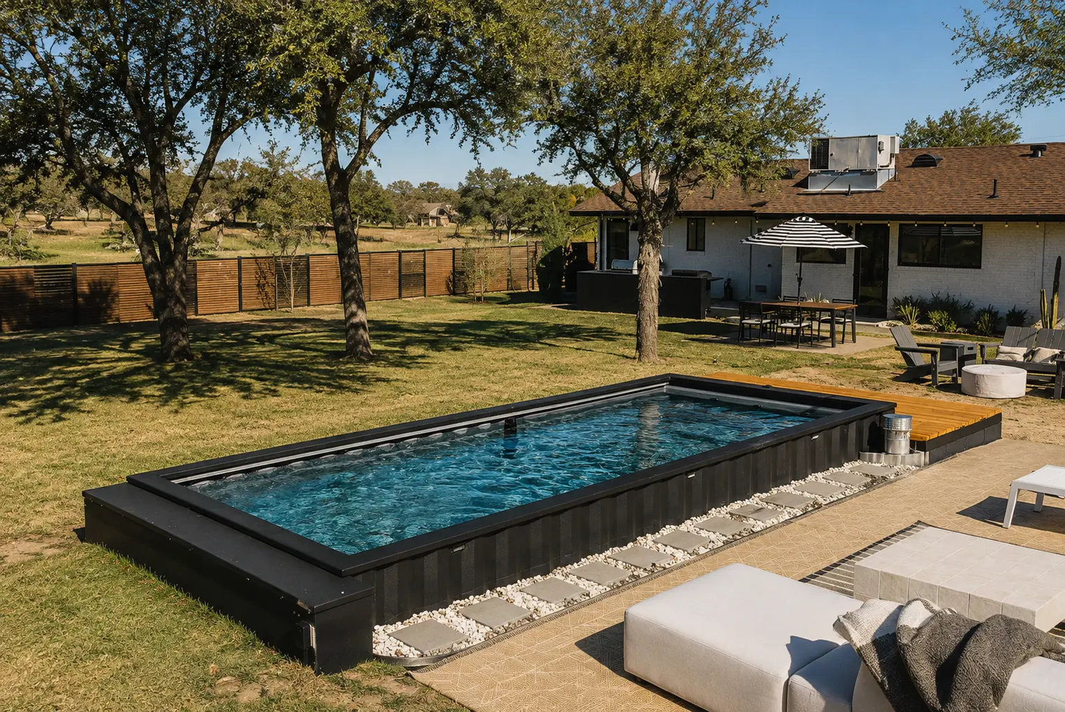 Black above-ground container pool in a Texas ranch backyard with stone paver entry